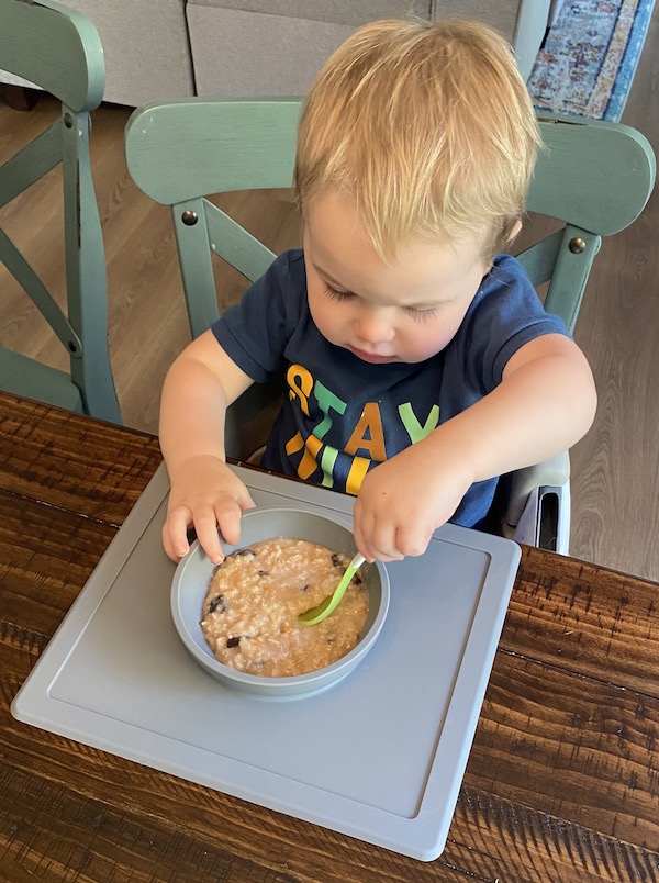 Boy eating carrot cake oatmeal from a bowl