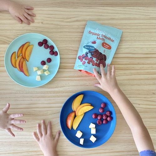 Toddlers eating snacks: peaches, cheese, and smoothie puffs (Toddler snack ideas)