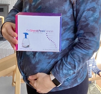Holding sneakpeek gender DNA kit box