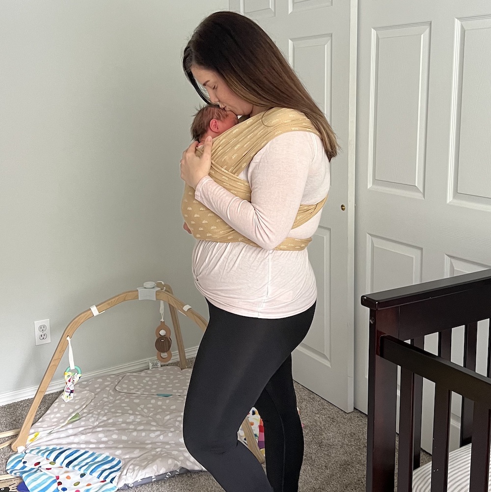 Women wearing solly baby wrap with newborn