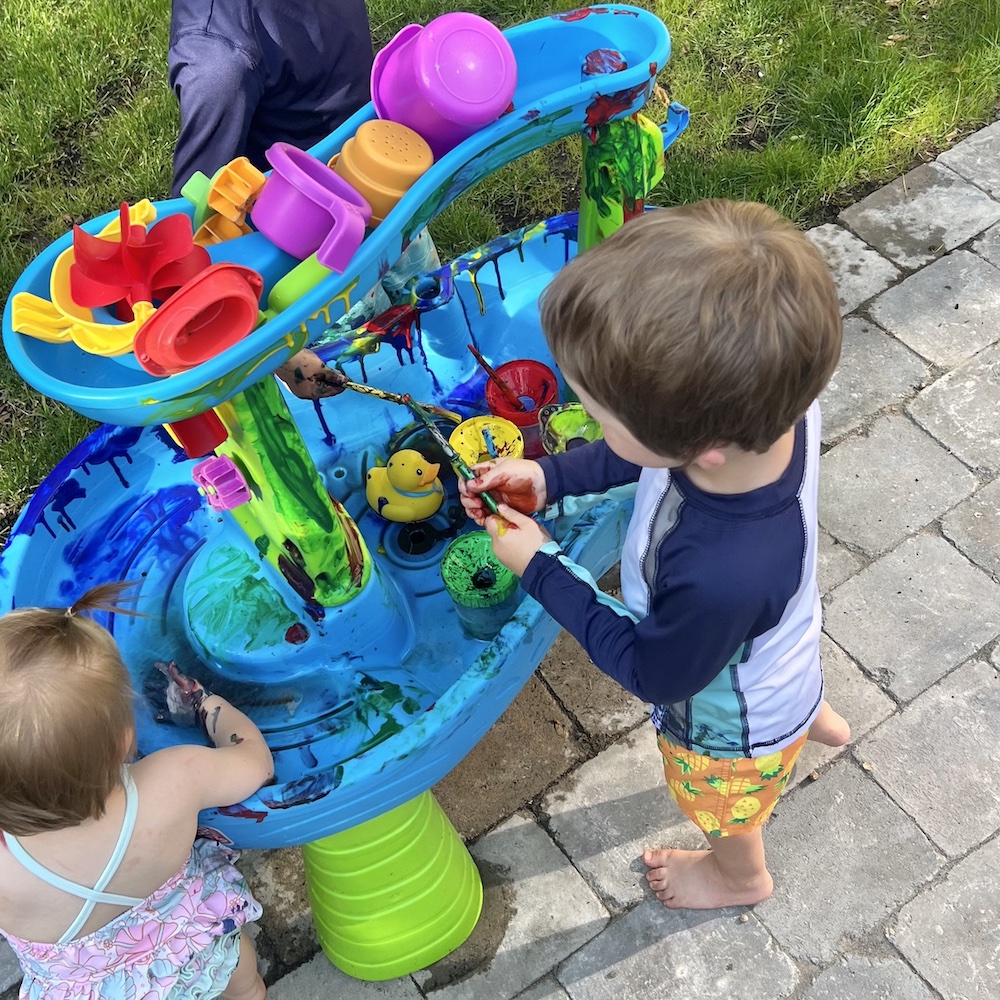 Kids painting the water table outside
