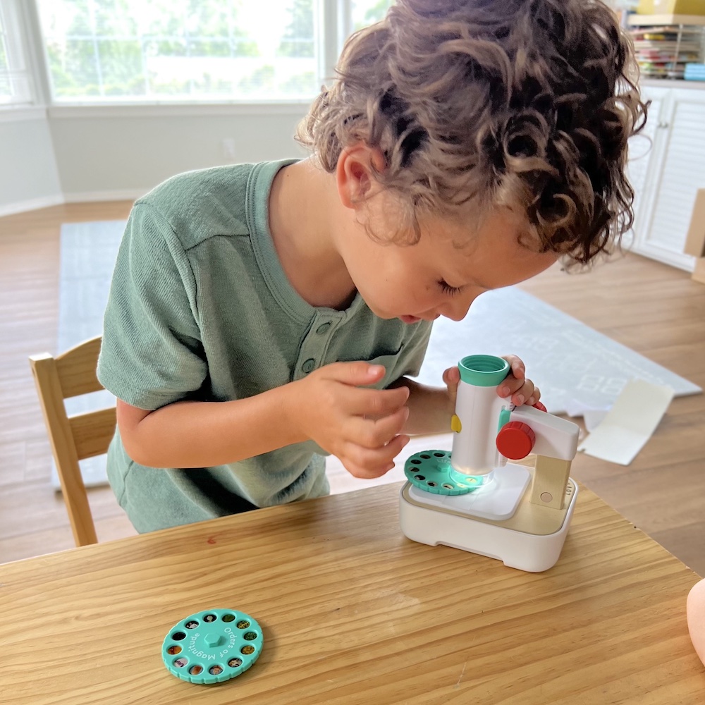 Boy with microscope - Lovevery - summer routine