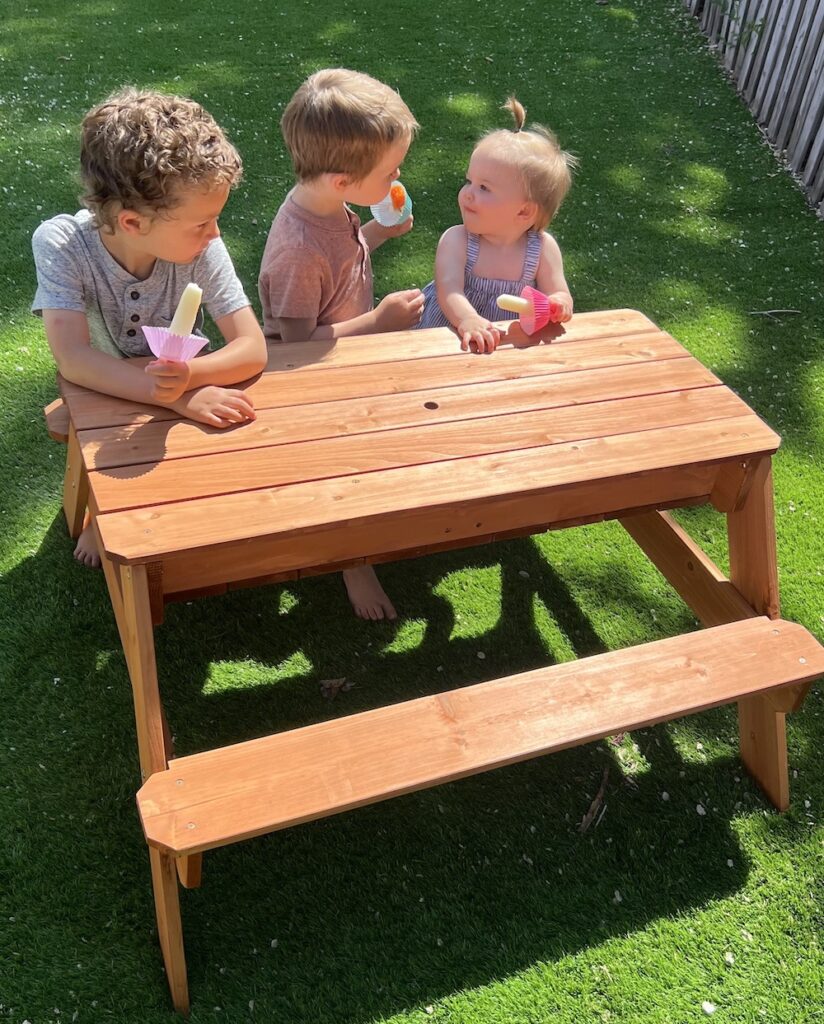 Kids sitting at kids sized picnic table