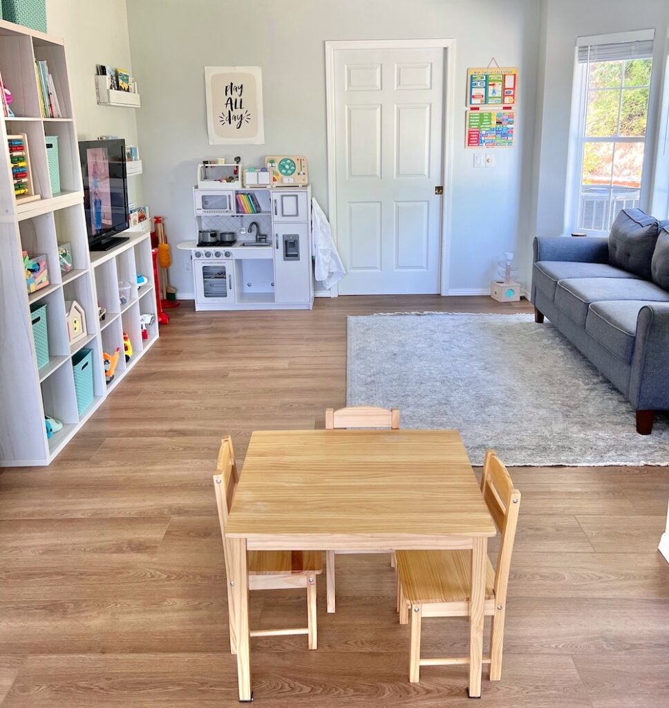 Playroom with rug, storage, and play kitchen