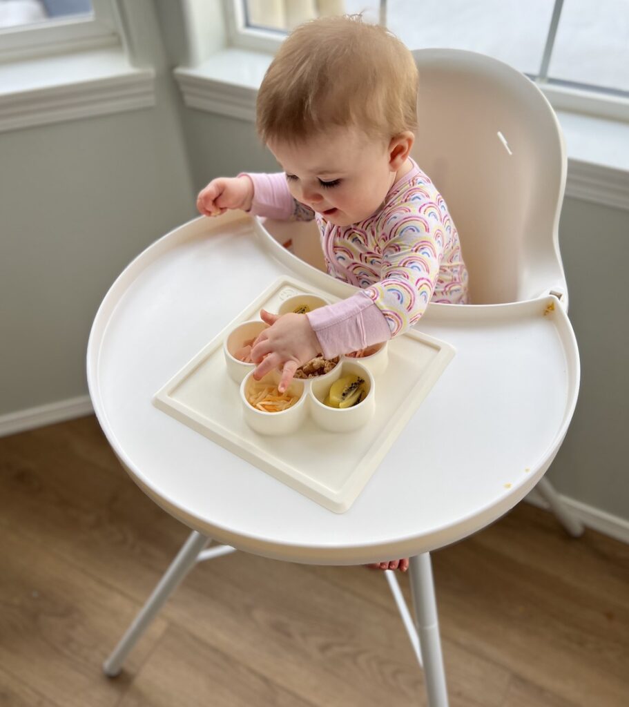 Baby in high chair (baby registry must-have)