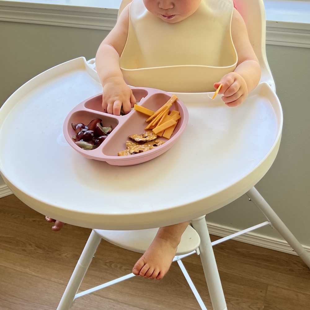 baby eating lunch at highchair